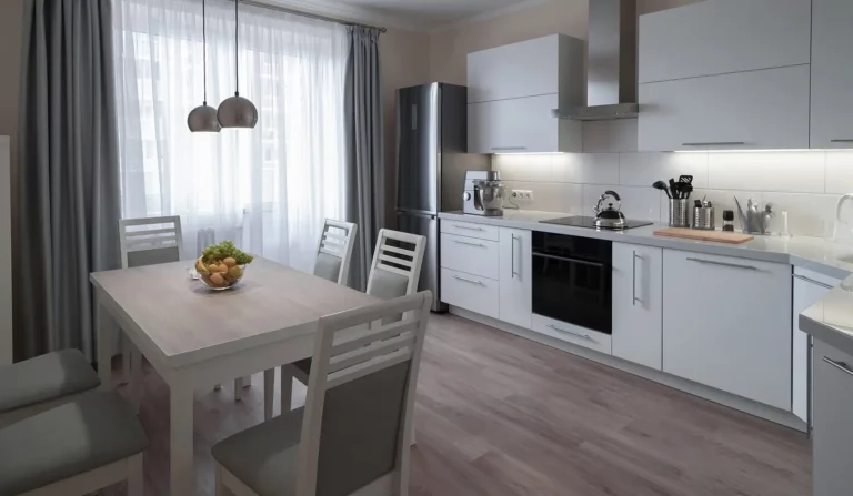 Clean design kitchen with muted grey tones, white cupboards and pay weekly vinyl flooring fit by easipay carpets